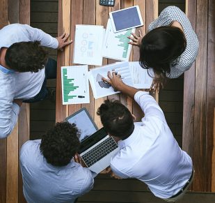 High angle shot of a team of businesspeople having a meeting outside